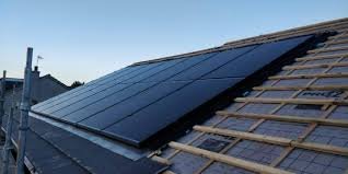 Small wind turbine mounted on a pole with a clear sky